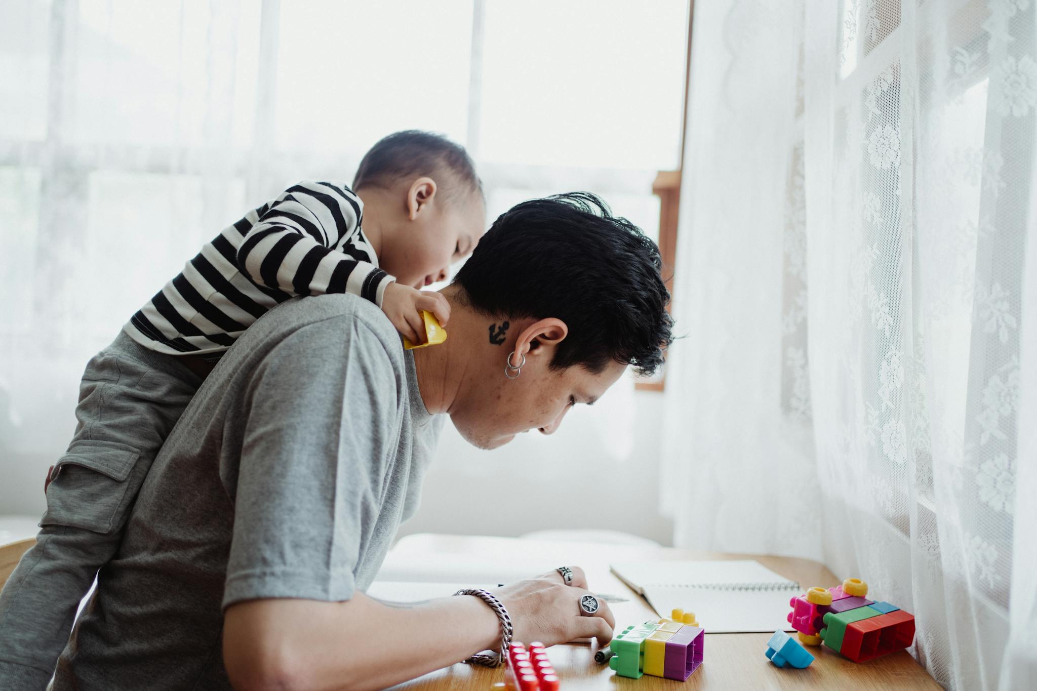 Father and Son Playing with Lego Pieces 